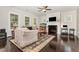 Open-concept living room with hardwood floors, fireplace, and views into other rooms at 1726 Rapids Ct, Franklinton, NC 27525