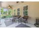 Covered back porch with wicker furniture set and ceiling fans for outdoor relaxation at 1726 Rapids Ct, Franklinton, NC 27525