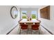 Bright dining room featuring a large window with natural light, seating for six and modern decor at 182 E Fountainhead Ln, Garner, NC 27529