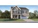 Charming two-story home with gray siding, stone accents, shutters, and a two-car garage at 182 E Fountainhead Ln, Garner, NC 27529
