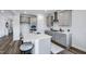 Modern kitchen featuring gray cabinets, subway tile backsplash, and a large island with seating at 182 E Fountainhead Ln, Garner, NC 27529