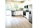 Modern kitchen with white cabinets, stainless appliances, and granite countertops at 189 Seville Way, Clayton, NC 27520