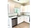 Bright kitchen featuring stainless steel dishwasher and granite countertops at 189 Seville Way, Clayton, NC 27520