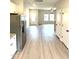 Stylish living area featuring sleek flooring, seamlessly connecting the kitchen and living room at 189 Seville Way, Clayton, NC 27520