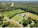 Aerial view of home, showcasing a large lot, mature trees, long driveway, and a spacious lawn at 190 Mitchells Chapel Road, Pittsboro, NC 27312