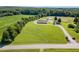 Expansive aerial view of a country home with sprawling lawn, mature trees and outbuildings at 190 Mitchells Chapel Road, Pittsboro, NC 27312