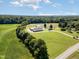 An aerial view of the property featuring the house and vast green land at 190 Mitchells Chapel Road, Pittsboro, NC 27312