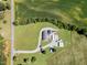 Aerial view of country home on large lot, featuring multiple structures, long driveway, and ample parking at 190 Mitchells Chapel Road, Pittsboro, NC 27312