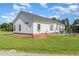 Exterior rear view of home with white siding, a spacious yard, and patio area at 190 Mitchells Chapel Road, Pittsboro, NC 27312