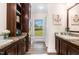 Bathroom with double sinks, lots of storage, a view to the backyard, and wood floor at 190 Mitchells Chapel Road, Pittsboro, NC 27312