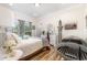 Bedroom with large window, neutral tones, wood floor, and a tanning bed at 190 Mitchells Chapel Road, Pittsboro, NC 27312