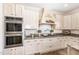 Detailed kitchen cabinetry, a range hood, stainless steel oven, and granite countertops offer plenty of space at 190 Mitchells Chapel Road, Pittsboro, NC 27312
