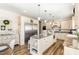 Open kitchen featuring a large island with seating, stainless steel appliances, and wood-look floors at 190 Mitchells Chapel Road, Pittsboro, NC 27312