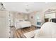 Charming primary bedroom featuring a chandelier, a decorative accent wall, and ample natural light at 190 Mitchells Chapel Road, Pittsboro, NC 27312