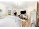 Bright and spacious primary bedroom with large windows, a crystal chandelier, and comfortable seating at 190 Mitchells Chapel Road, Pittsboro, NC 27312