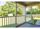 Covered back porch with white railings overlooks a large backyard at 1975 Oakridge Duncan Rd, Fuquay Varina, NC 27526