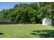 A large manicured backyard featuring a shed and fence at 1975 Oakridge Duncan Rd, Fuquay Varina, NC 27526