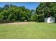 A large manicured backyard featuring a shed and some trees at 1975 Oakridge Duncan Rd, Fuquay Varina, NC 27526