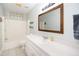 Bathroom with a large framed mirror, white vanity, tub, and shower at 1975 Oakridge Duncan Rd, Fuquay Varina, NC 27526