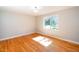 Spacious bedroom features hardwood floors and a bright window overlooking the backyard at 1975 Oakridge Duncan Rd, Fuquay Varina, NC 27526