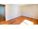 Bedroom with neutral walls, gleaming wood floors, and natural light at 1975 Oakridge Duncan Rd, Fuquay Varina, NC 27526