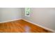 Bedroom with hardwood floors, neutral walls, a window, and white trim at 1975 Oakridge Duncan Rd, Fuquay Varina, NC 27526