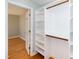 Walk-in closet with white shelving and a view to an adjacent bedroom at 1975 Oakridge Duncan Rd, Fuquay Varina, NC 27526