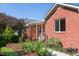 Exterior of a charming brick home with a covered front porch and well-manicured landscaping at 1975 Oakridge Duncan Rd, Fuquay Varina, NC 27526