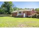 Brick house with a covered back porch and manicured lawn at 1975 Oakridge Duncan Rd, Fuquay Varina, NC 27526