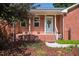 Inviting front porch with a decorative wreath on the light blue front door at 1975 Oakridge Duncan Rd, Fuquay Varina, NC 27526