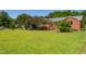 Spacious front yard with mature trees surrounding this well-maintained brick home at 1975 Oakridge Duncan Rd, Fuquay Varina, NC 27526