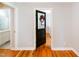 Hallway shows an open doorway with a floral wreath and bathroom on the left at 1975 Oakridge Duncan Rd, Fuquay Varina, NC 27526