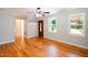 Open concept living area featuring hardwood floors and a coat rack by the door at 1975 Oakridge Duncan Rd, Fuquay Varina, NC 27526