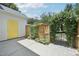 Fenced backyard with access gate and shed with yellow door at 2101 Piney Brook Rd # 102, Raleigh, NC 27614