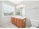 Bathroom featuring a double vanity, large mirror, and a window at 2101 Piney Brook Rd # 102, Raleigh, NC 27614