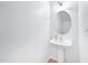 Bright bathroom featuring white walls, pedestal sink, and an oval mirror at 2101 Piney Brook Rd # 102, Raleigh, NC 27614