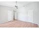 Spacious bedroom with light wood-look flooring, two doors, and a ceiling fan at 2101 Piney Brook Rd # 102, Raleigh, NC 27614