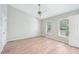 Spacious bedroom with ceiling fan, windows, and light wood-look flooring at 2101 Piney Brook Rd # 102, Raleigh, NC 27614