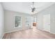 Bright bedroom with ceiling fan, two windows, and light wood-look flooring at 2101 Piney Brook Rd # 102, Raleigh, NC 27614