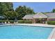 Community pool area with lounge chairs and covered area at 2101 Piney Brook Rd # 102, Raleigh, NC 27614