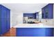 Charming kitchen features blue cabinets, stainless appliances, and granite countertops at 2101 Piney Brook Rd # 102, Raleigh, NC 27614