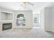 Bright and airy living room with a fireplace, arched window, and views to another room at 2101 Piney Brook Rd # 102, Raleigh, NC 27614