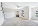 Cozy living room with a fireplace, carpet floors, a ceiling fan, and lots of natural light at 2101 Piney Brook Rd # 102, Raleigh, NC 27614