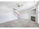 Bright living room with fireplace, staircase, and neutral carpet flooring at 2101 Piney Brook Rd # 102, Raleigh, NC 27614