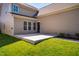 Exterior view of backyard featuring a concrete patio and well-maintained grassy area at 2129 Glade Valley Ln, Morrisville, NC 27560