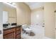 Full bathroom with white tiled walls, vanity with granite top, soaking tub, and elongated toilet at 2129 Glade Valley Ln, Morrisville, NC 27560