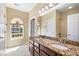 Elegant bathroom boasts double sinks, granite countertops, a large mirror, and natural light at 2129 Glade Valley Ln, Morrisville, NC 27560
