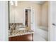 Bathroom with vanity sink, granite countertops, bathtub-shower combo, and neutral-toned decor at 2129 Glade Valley Ln, Morrisville, NC 27560