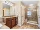 Well-appointed bathroom featuring a glass-enclosed shower, vanity with granite countertop, and neutral finishes at 2129 Glade Valley Ln, Morrisville, NC 27560