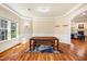 Bright dining room with hardwood floors, large windows, and a wooden table with benches at 2129 Glade Valley Ln, Morrisville, NC 27560